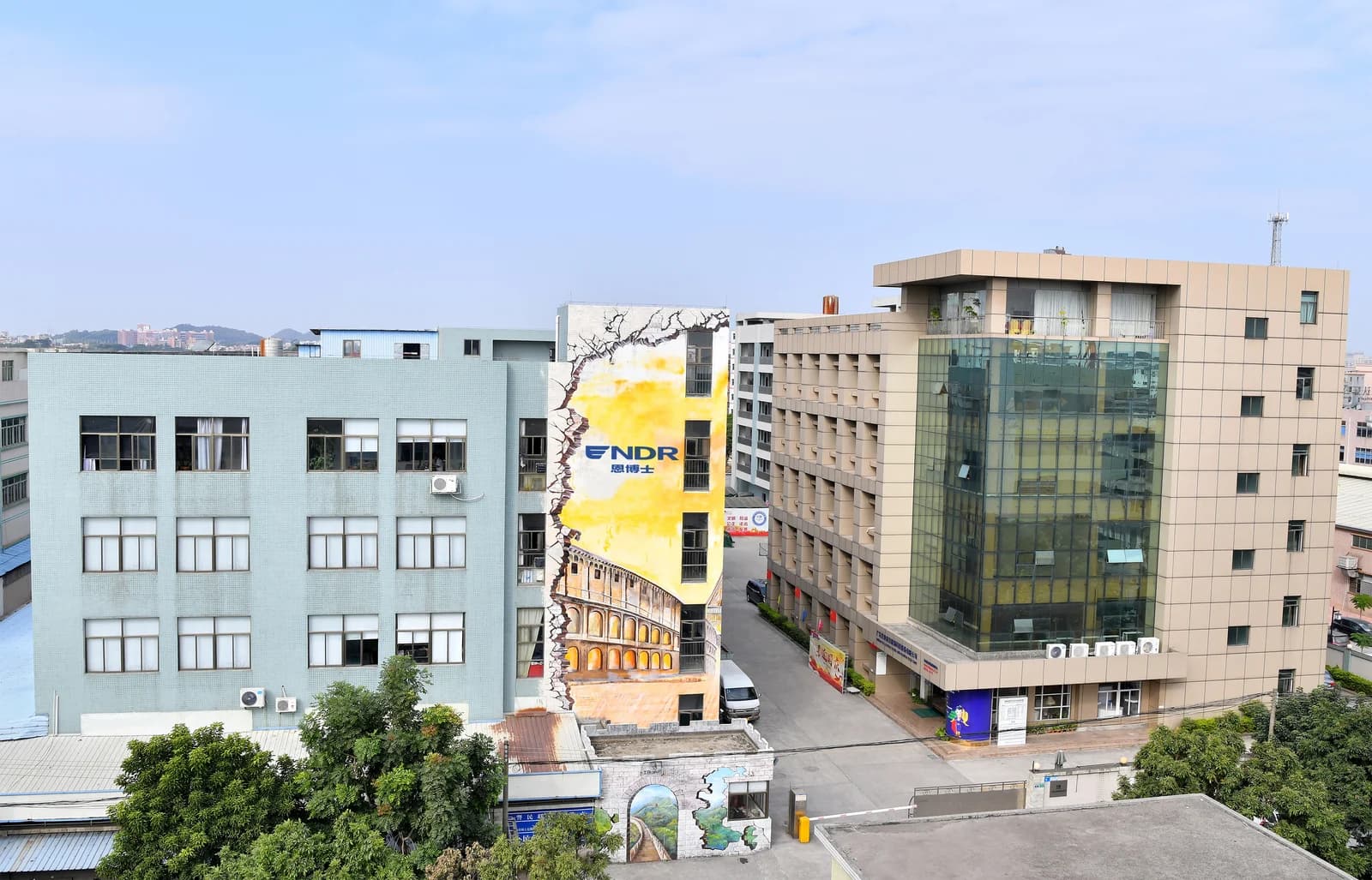Exterior view of the company buildings, courtyard, and colorful facade in Dongguan