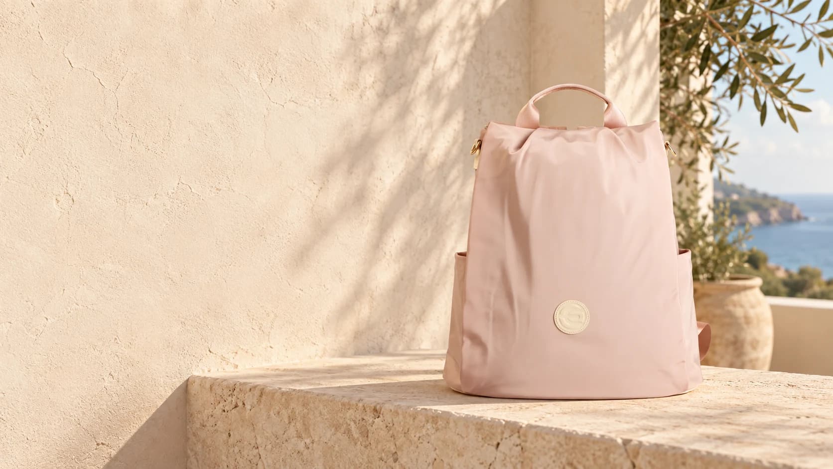 Blush pink e.Both bag on a warm, sunlit terrace